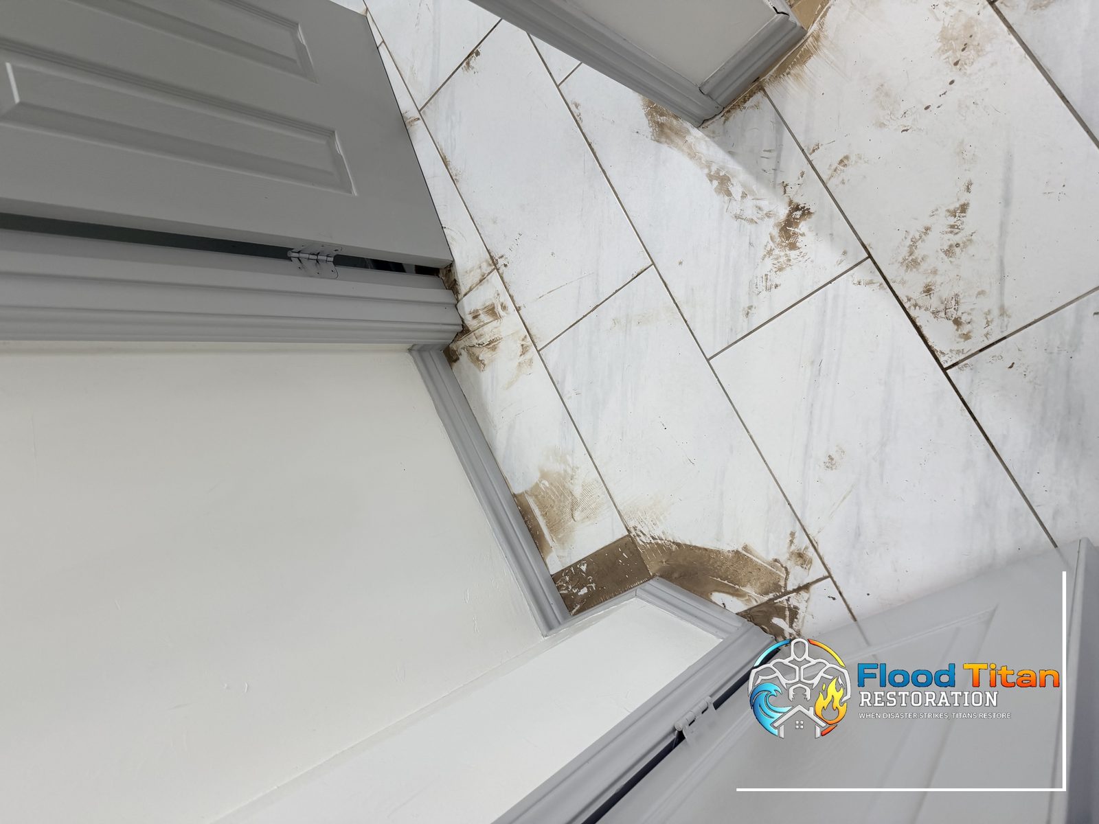 Tile floor with mud and water staining showing flood damage documented by Flood Titan Restoration
